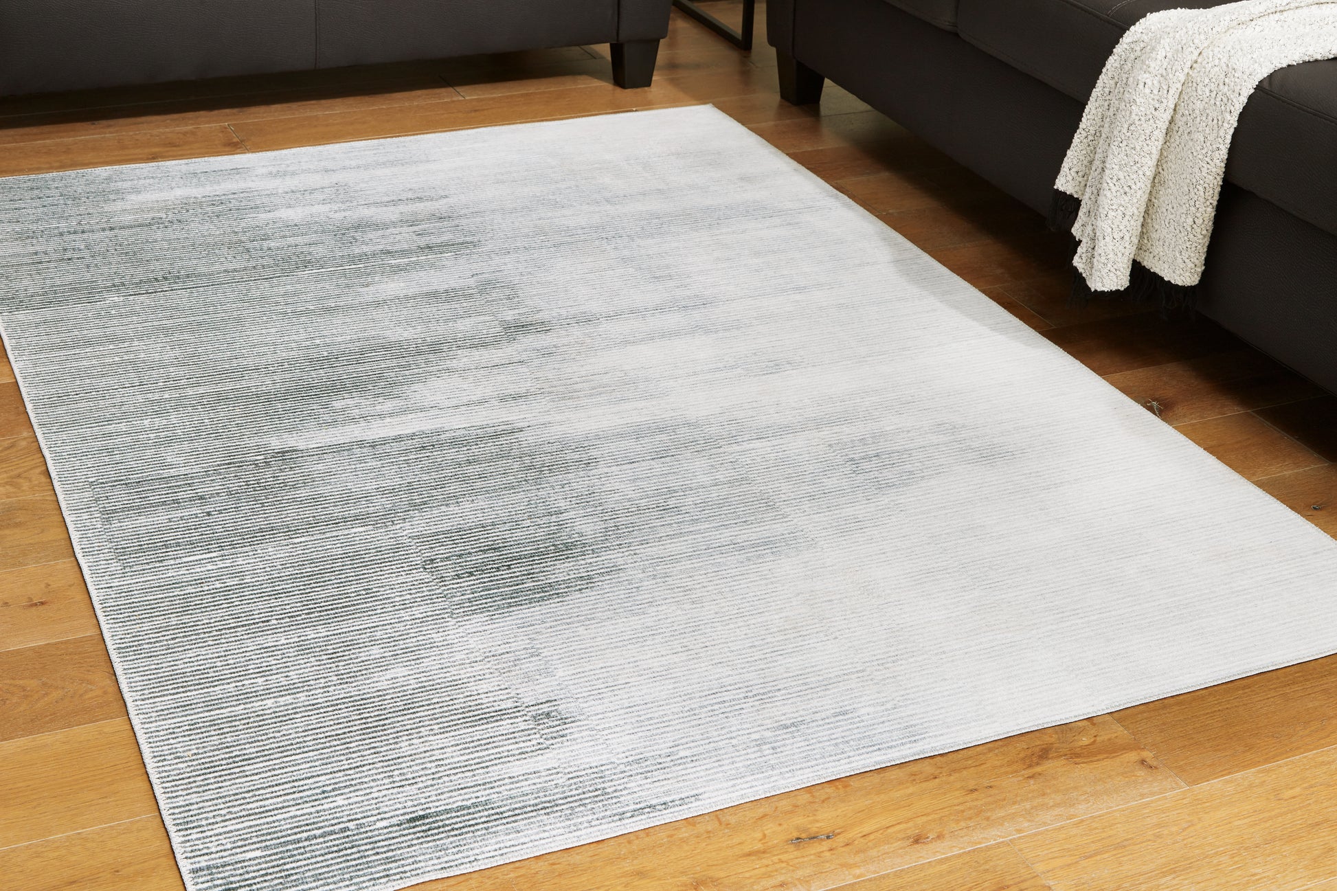Cassel Furniture Outlet - Ashley Furniture - Milset Rug - 8'1" x 10' Washable Rug / Black/White/Gray - R406251