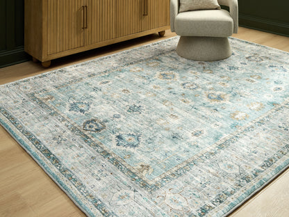 Cassel Furniture Outlet - Ashley Furniture - Ladstoney Rug - 7'6" x 9'6" Area Rug / Teal/Beige/Ochre - R407501